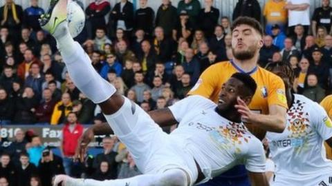 Jamille Matt of Newport County tries to get a shot at goal
