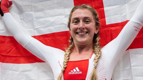 Laura Kenny of Team England celebrates with their flag after winning Gold in the Women's 10km Scratch Race on day four of the Birmingham 2022 Commonwealth Games at Lee Valley Velopark Velodrome on August 01, 2022 on the London, England