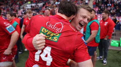 A smiling Dwayne Peel and Tom Rogers embrace after Scarlets beat Leinster in April 