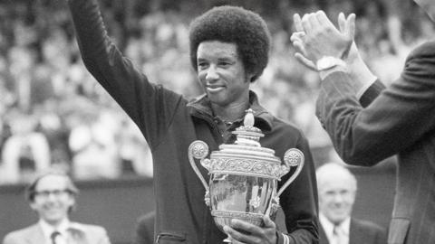 Arthur Ashe with the Wimbledon trophy