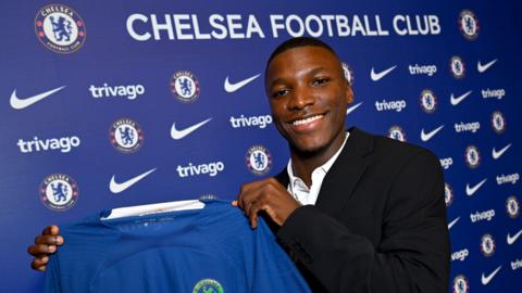 Moises Caicedo holds a Chelsea shirt after signing for the club