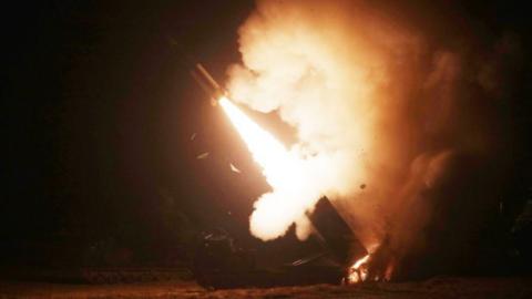 A ATAMCS missile launcher fires at night