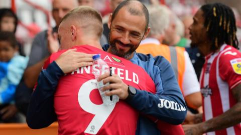 Jay Stansfield hugs Wayne Carlisle