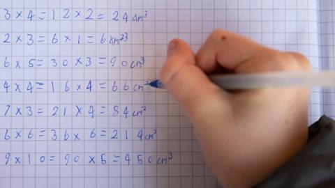 View over the shoulder of a pupil doing maths