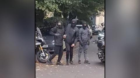 The men attempt to break the chain on a motorbike with a hammer