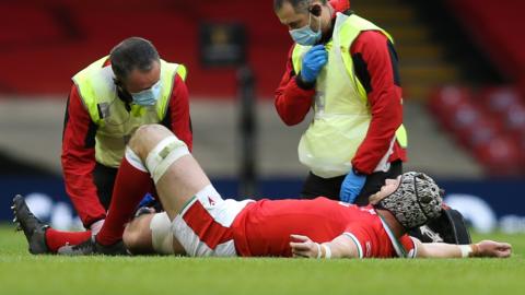 Wales flanker Dan Lydiate has treatment on the field
