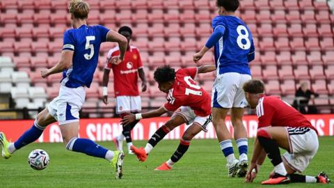 Manchester United forward JJ Gabriel gets in a shot in against Ipswich