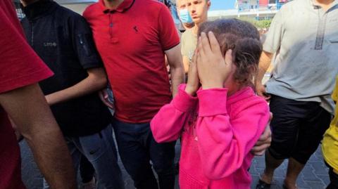 A girl reacts to a hit on a UN school in Gaza