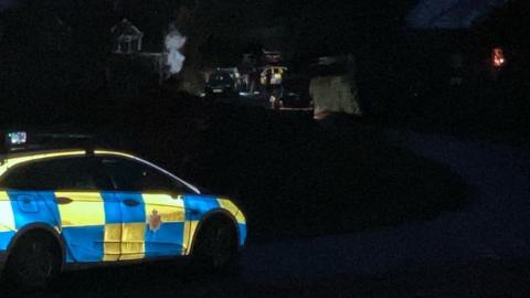 Police cars outside a property in Hasfield