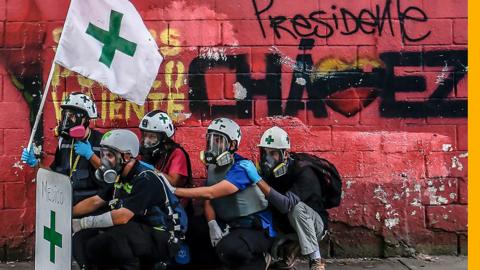 Green Cross are Venezuela's volunteers who go around Caracas helping those injured on the front line.