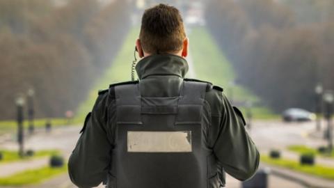 PSNI officer at Parliament Buildings, Stormont, Belfast, not wearing a tie or hat for safety, due to the difficulty of disinfecting on regular bases in light of the Covid-19 pandemic