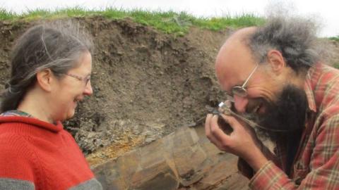 Lucy Muir and Joe Botting examining a fossil specimen at Castle Bank