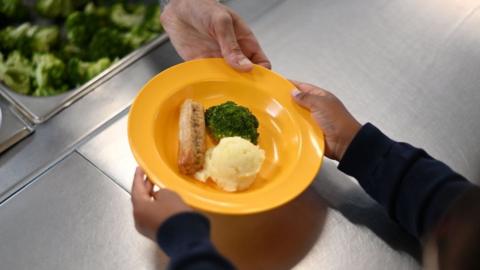 Pupil handed plate of food