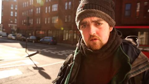 A homeless man awaits a hotel place during the coronavirus outbreak.