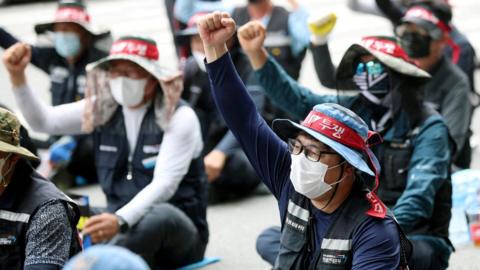 Members of the Cargo Truckers Solidarity union take part in a protest in front of Kia Motor's factory tin Gwangju, South Korea.