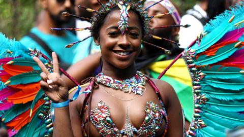 Revellers attend the Notting Hill Carnival on 28 August 2023 in London, England