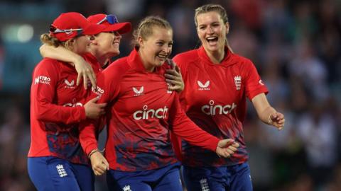 England cricketers Sophie Ecclestone (middle), Lauren Bell (right), Charlie Dean and Heather Knight celebrate a wicket