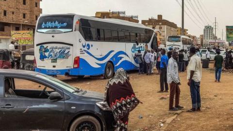 People board buses in Khartoum
