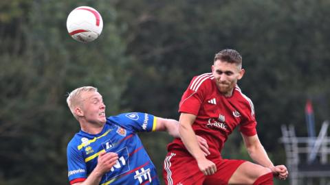 Connah's Quay Nomads' Callum Bratley wins the header against KA's Bjarni Adalsteinsson