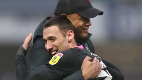 Vincent Kompany and Darko Churlinov sharing a celebratory hug after Burnley's win against Queen's Park Rangers in December