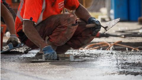 Workers pour concrete on the Langeais viaduct bridge deck at a construction site to double its width on highway A85, near Langeais, central France