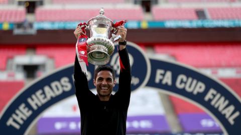 Arsenal boss Mikel Arteta holds up the FA Cup at Wembley stadium after his side won the 2020 final against Chelsea behind closed doors