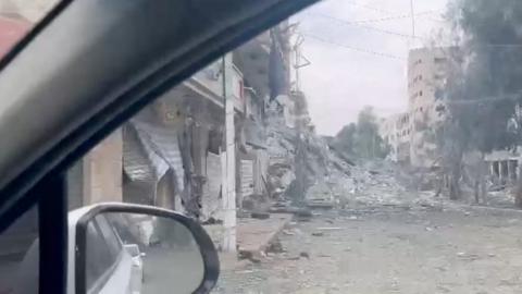 Demolished building seen through car window