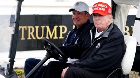 Donald Trump on a golf buggy at Turnberry