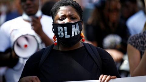 A woman wearing a BLM face mask during a Black Lives Matter protest in London