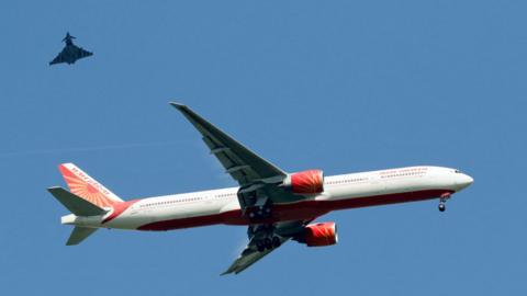 Air India Boeing 777-300 with an RAF Typhoon escort over Sawbridgeworth, in Hertfordshire