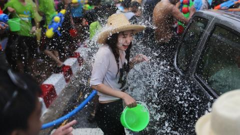 Tourists and Thai residents take part in a city-wide water fight during the Songkran water festival on April 14, 2014