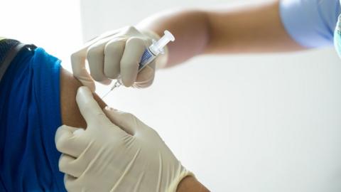 A person being given the vaccine