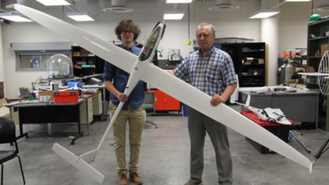 Researchers hold an experimental sailplane.