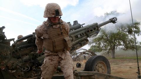 Sgt. Joseph Reed Jr., training chief, Headquarters and Service company, Battalion Landing Team 2nd Battalion, 1st Marines, (BLT 2/1), 11th Marine Expeditionary Unit, fires his first M777A2 Howitzer round as part of a Tactical Air Control Party (TACP) exercise during Realistic Urban Training Marine Expeditionary Unit Exercise (RUTMEUEX) 14-1 at Camp Roberts, California (26 March 2014)