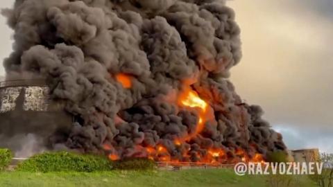 Thick, dark smoke fills the sky above the depot after it was reportedly hit by a drone.