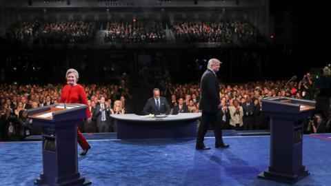 Democratic presidential nominee Hillary Clinton and Republican presidential nominee Donald Trump walk to their podiums to start the presidential debate at Hofstra University in Hempstead, N.Y., Monday, Sept. 26, 2016