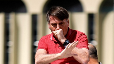 Jair Bolsonaro coughs at a rally in April 2020