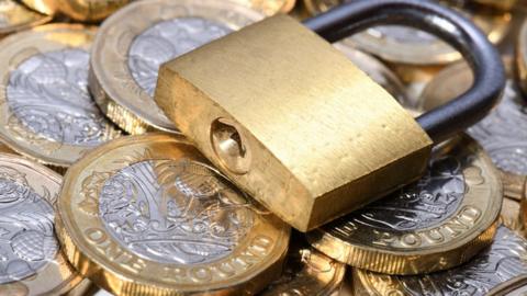 Padlock on coins