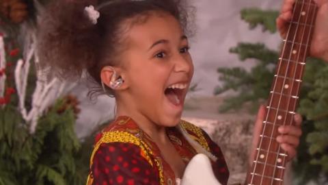 Nandi Bushell looking happy when she receives the guitar from Elle DeGeneres