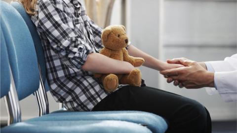 Child with teddy, with doctor