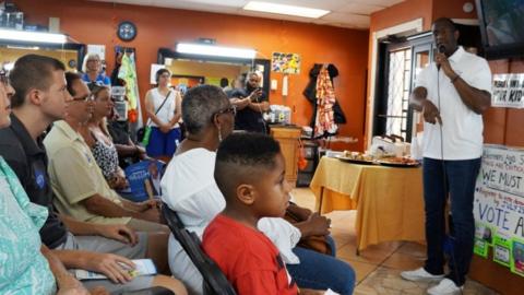 Andrew Gillum campaigns in a barbershop to become the governor of Florida