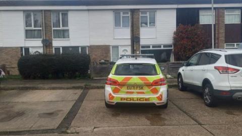 Police car outside a house in Elsenham Crescent in Basildon.