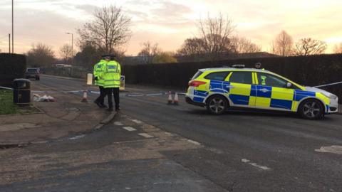 Police and flowers at the scene