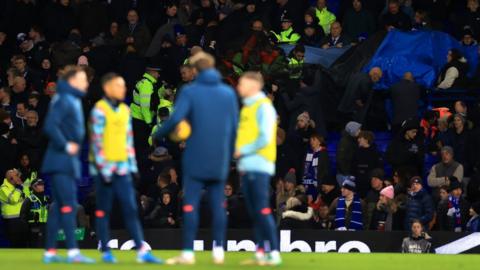 Medics attend to a supporter during half-time