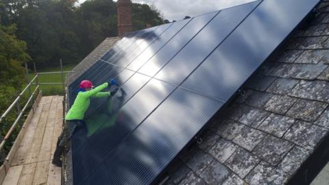 Solar panel being installed on a house