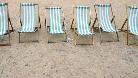 Deckchairs are seen on parched grass in Hyde Park in London.