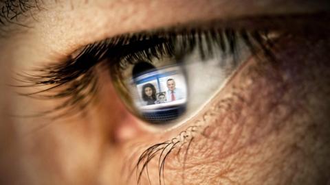 Stock image of a video call reflecte in a person's eye