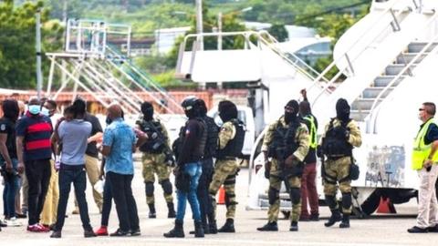 Haitian migrants gather in Port-au-Prince after getting off a plane from Texas