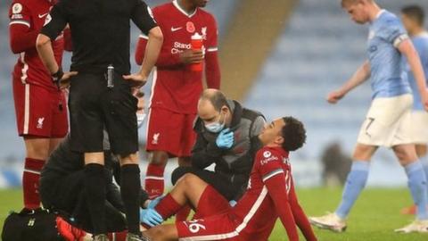 Trent Alexander-Arnold is treated after picking up an injury against Manchester City