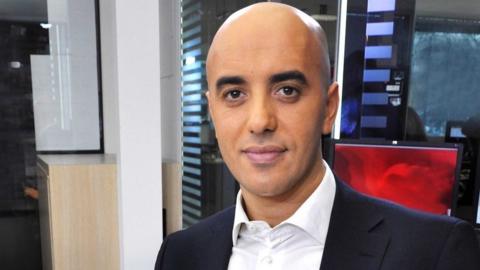 A head and shoulders picture of Redoine Faid in a white shirt and suit